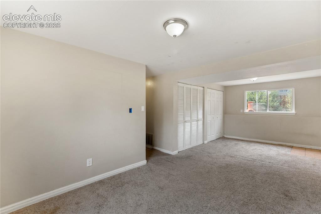 Image 12 of 23: Spacious lower-level family room with natural light