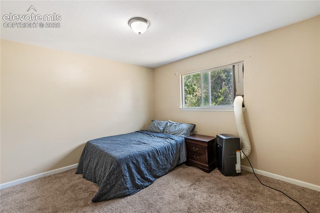 Image 17 of 23: Main-level bedroom with natural light