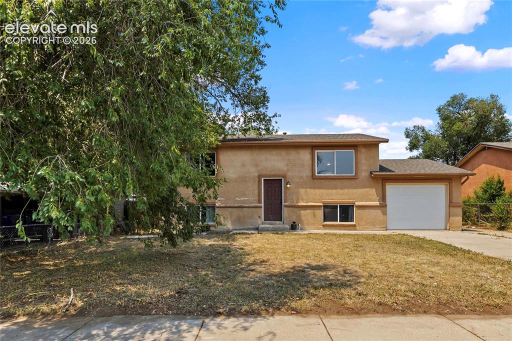 Image 2 of 23: Welcoming front entry with spacious driveway