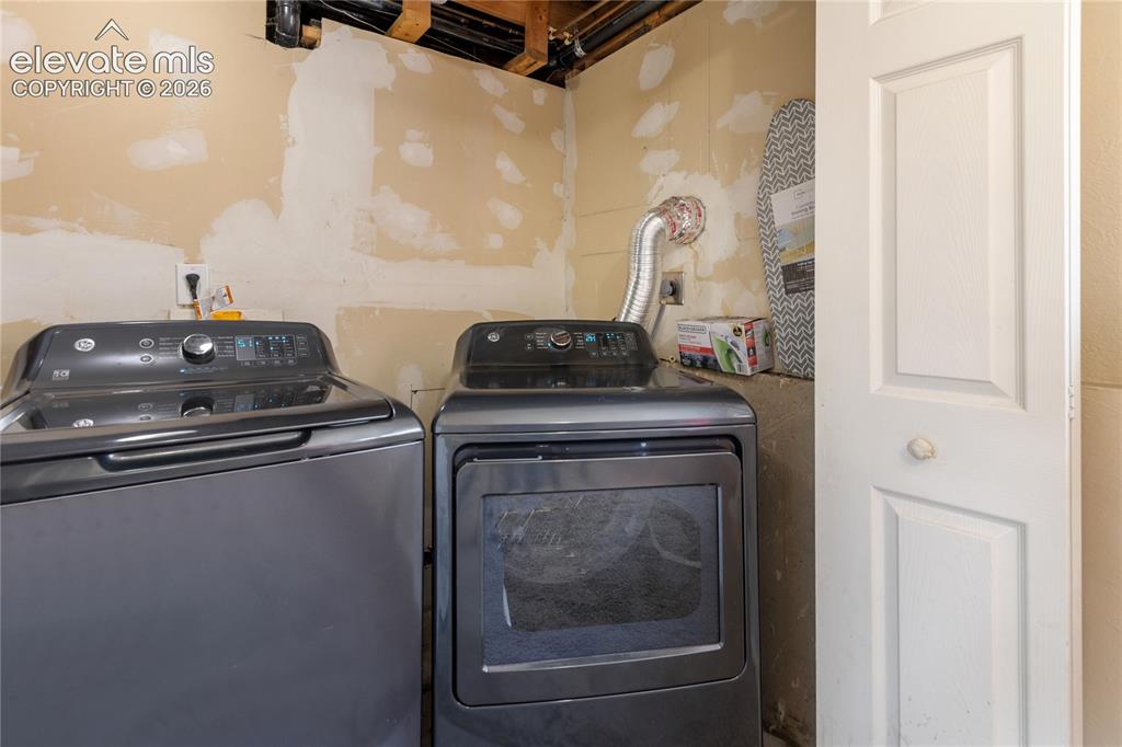 Image 20 of 23: Dedicated laundry area with additional storage space