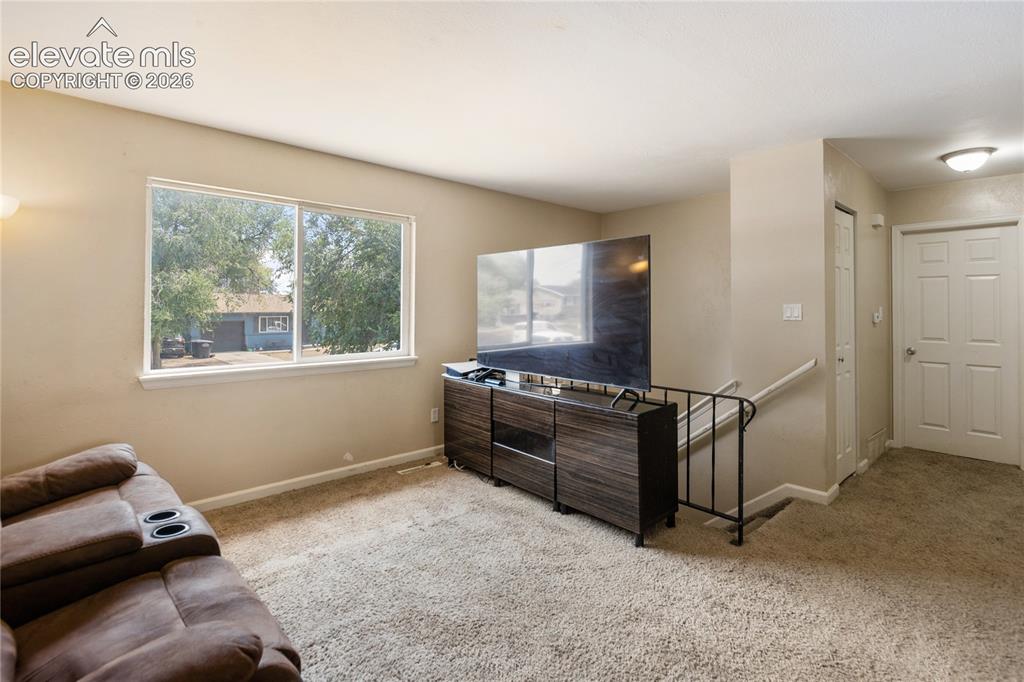 Image 5 of 23: Bright living room with large front-facing window