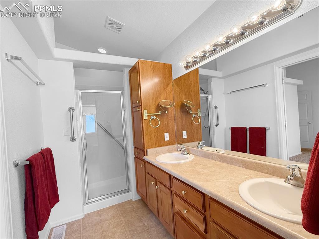 Image 21 of 46: 5 piece bath for primary with walk in shower.