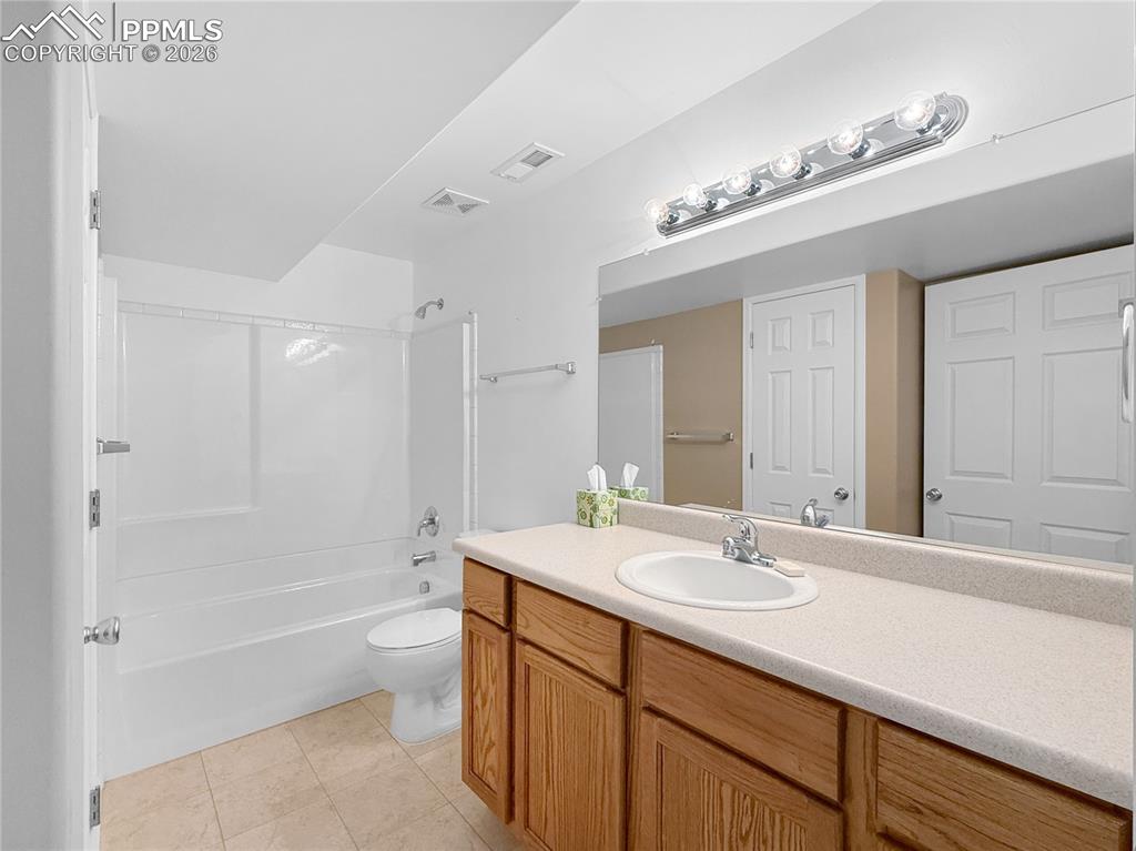 Image 32 of 46: Basement bathroom complete with closet storage.
