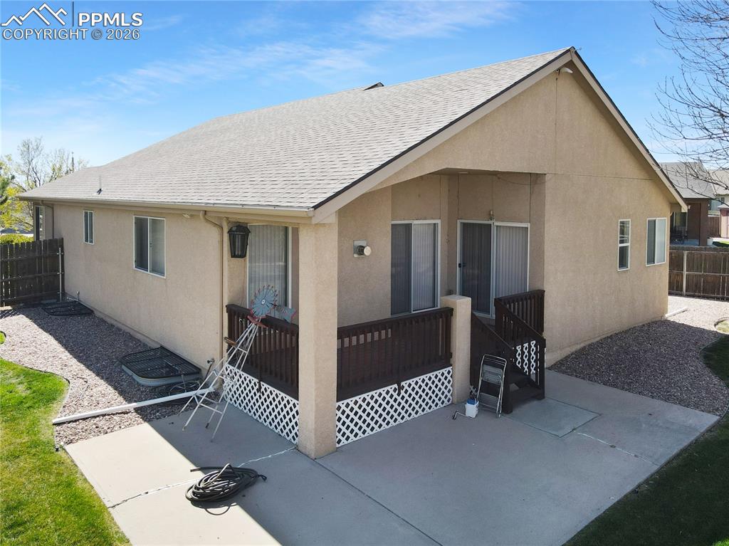 Image 36 of 46: Covered deck and patio area.