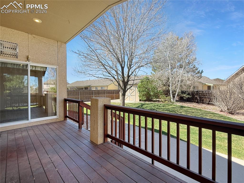 Image 38 of 46: Covered deck with two entrances from the home.