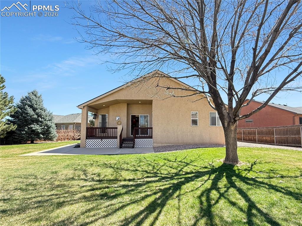 Image 40 of 46: Back yard with mature trees getting ready to bloom.