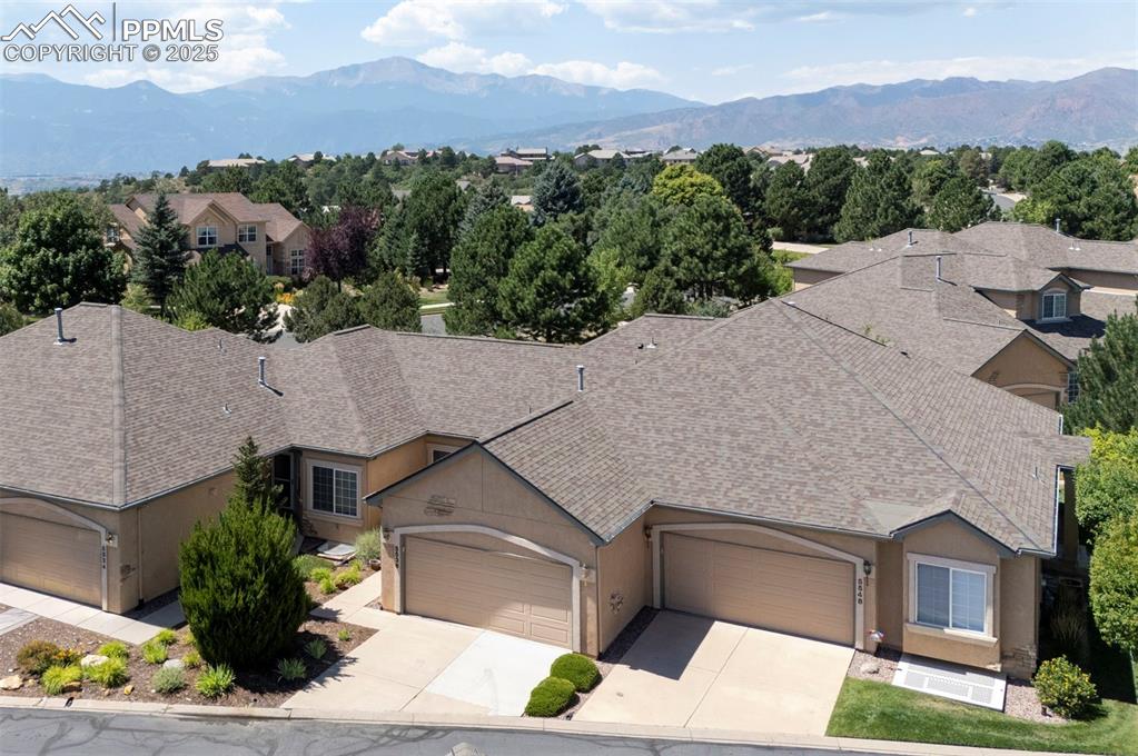 Image 3 of 42: View of front of home featuring a mountain view, driveway, an attached gara
