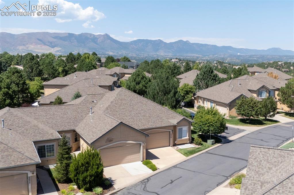 Image 5 of 42: Aerial view of residential area featuring mountains