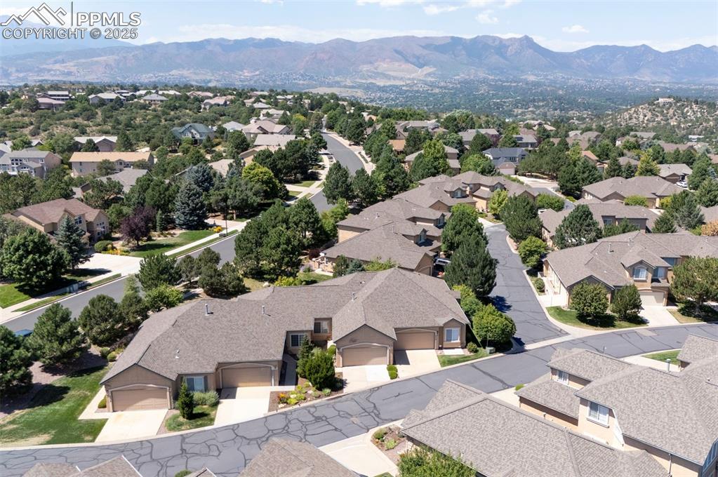Image 6 of 42: Aerial perspective of suburban area featuring a mountainous background