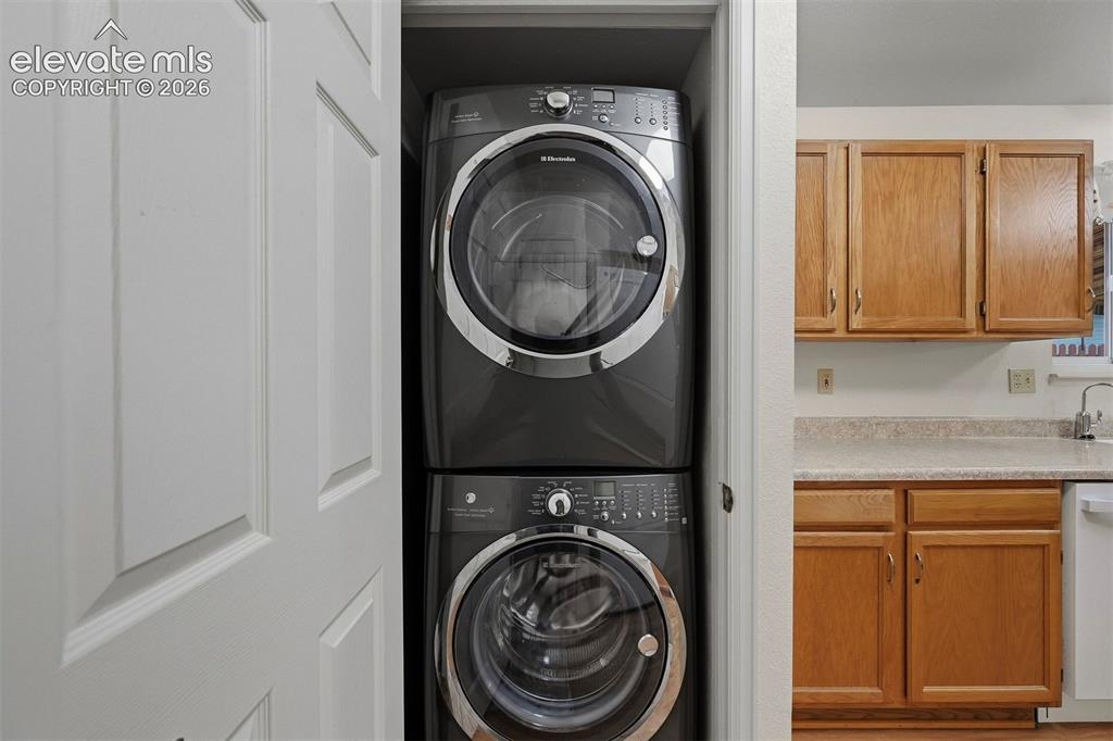 Image 18 of 40: Laundry 1 is a stackable laundry with washer and dryer in kitchen