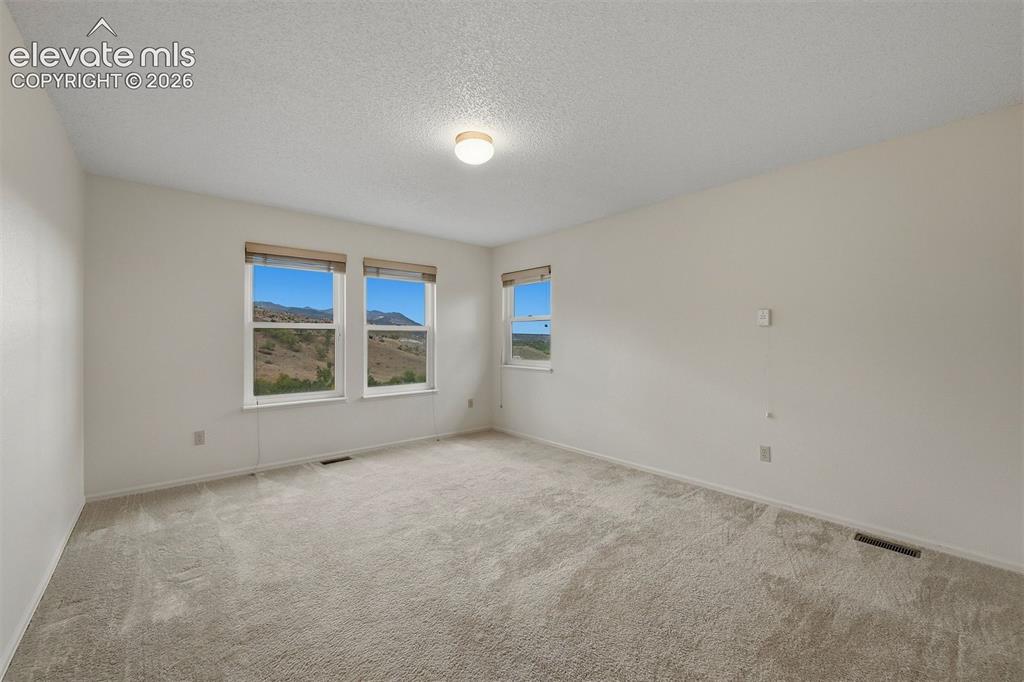 Image 22 of 40: 2nd bedroom on back of home with Garden of the Gods views