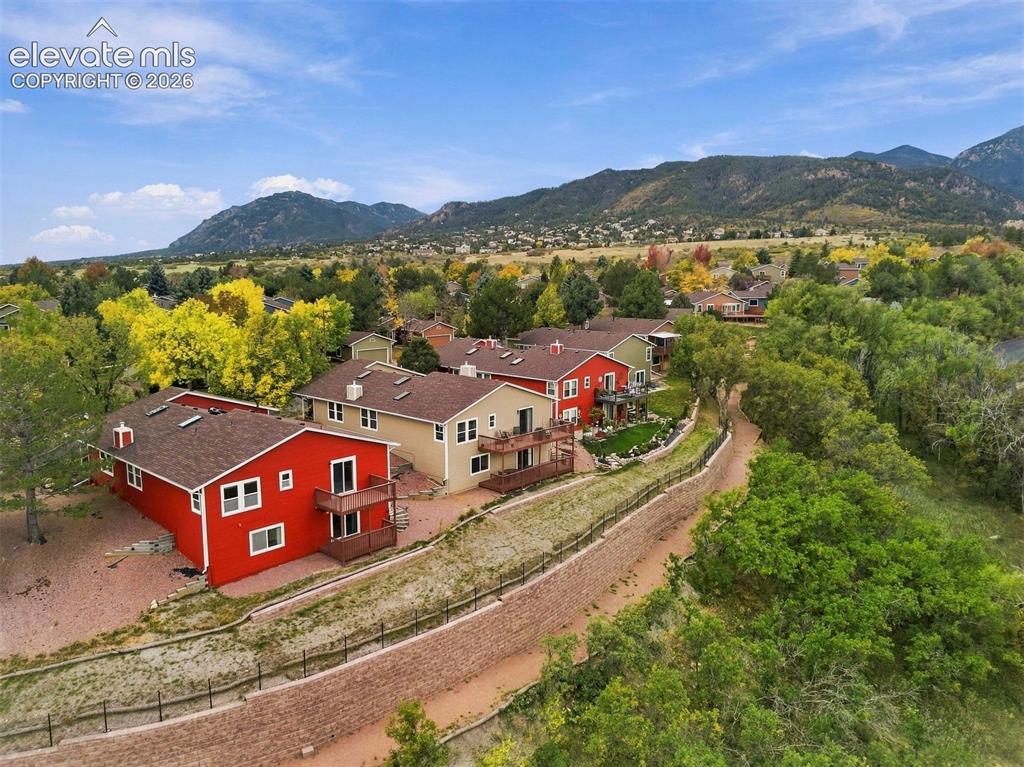 Image 37 of 40: Back row of homes backing to HOA-owned open area. 