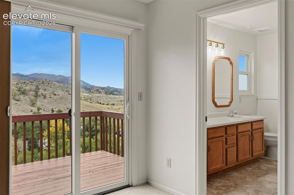 Image 8 of 40: Primary bedroom walk out to private deck. 