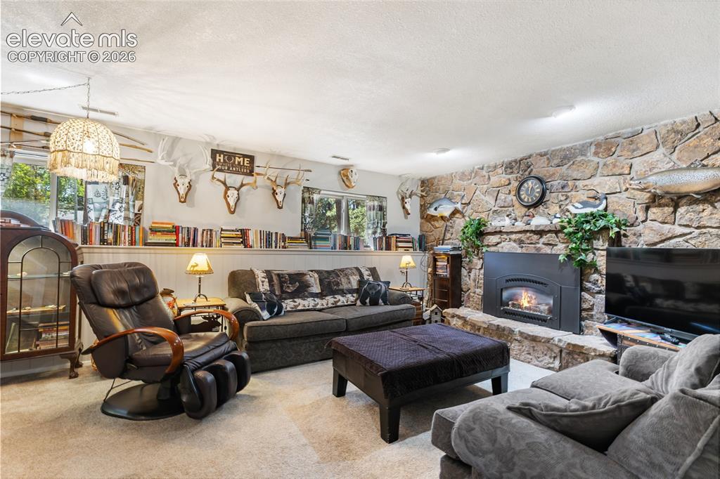Image 20 of 39: Stone accent wall featuring a built-in fireplace