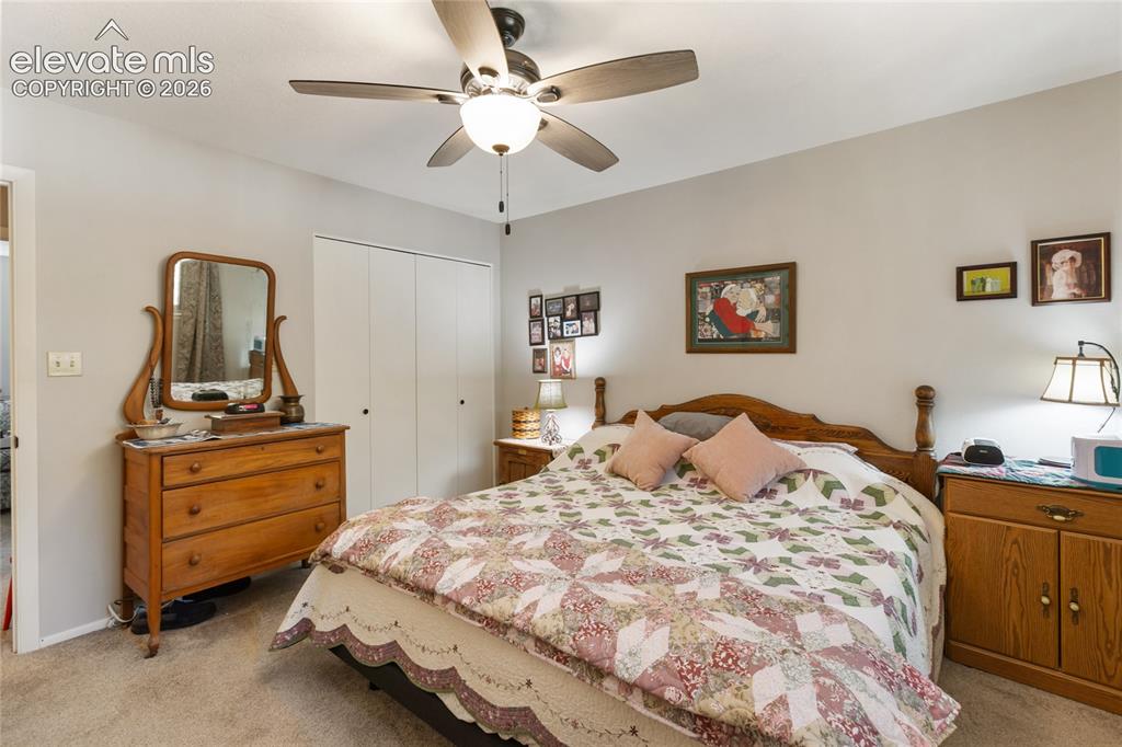 Image 30 of 39: Wall-to-wall carpeting and a ceiling fan with integrated lighting