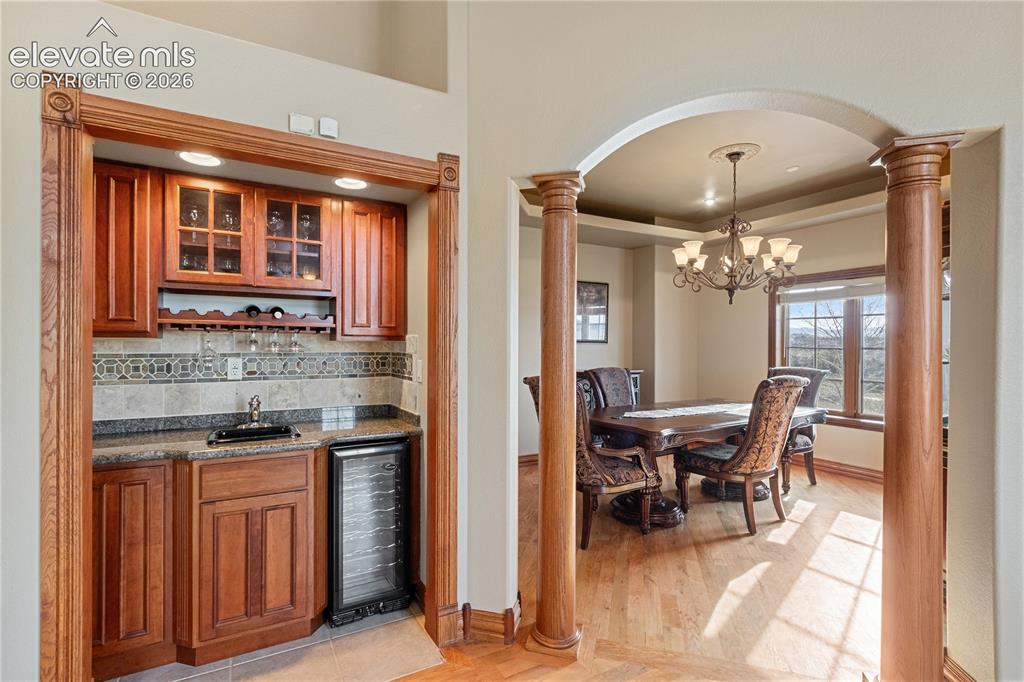 Image 11 of 50: Living room with fireplace, dining room off to the left