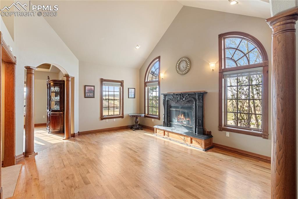 Image 12 of 50: Living room with fireplace, dining room off to the left