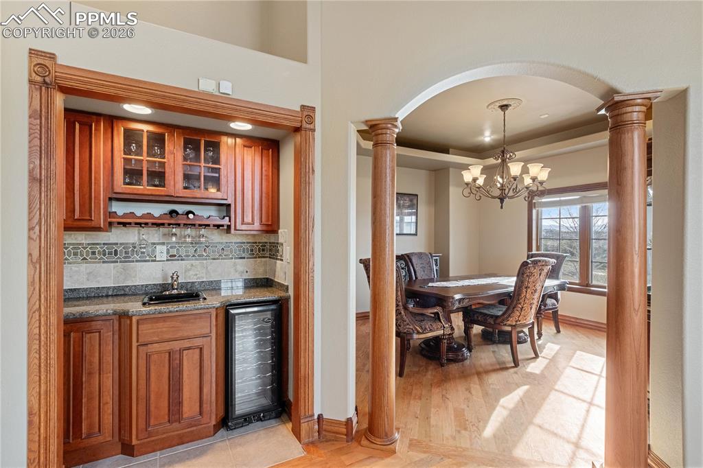 Image 13 of 50: Wet bar in living room, looking into dining room