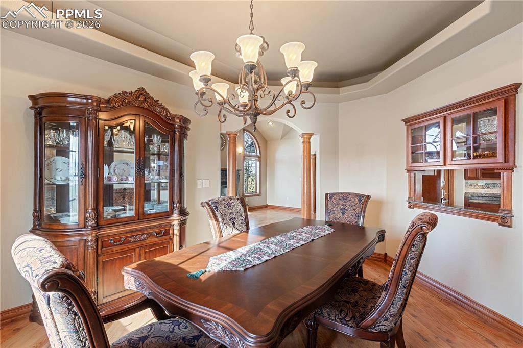 Image 14 of 50: Dining room, looking into living room. Window to kitchen.
