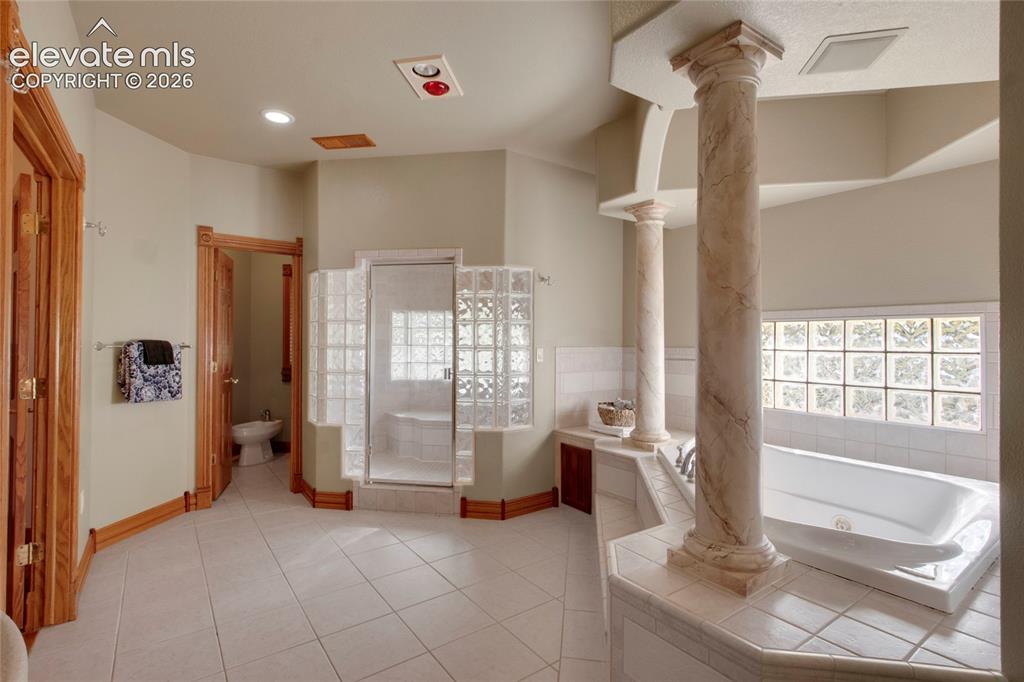 Image 17 of 50: Primary bathroom, looking toward bedroom