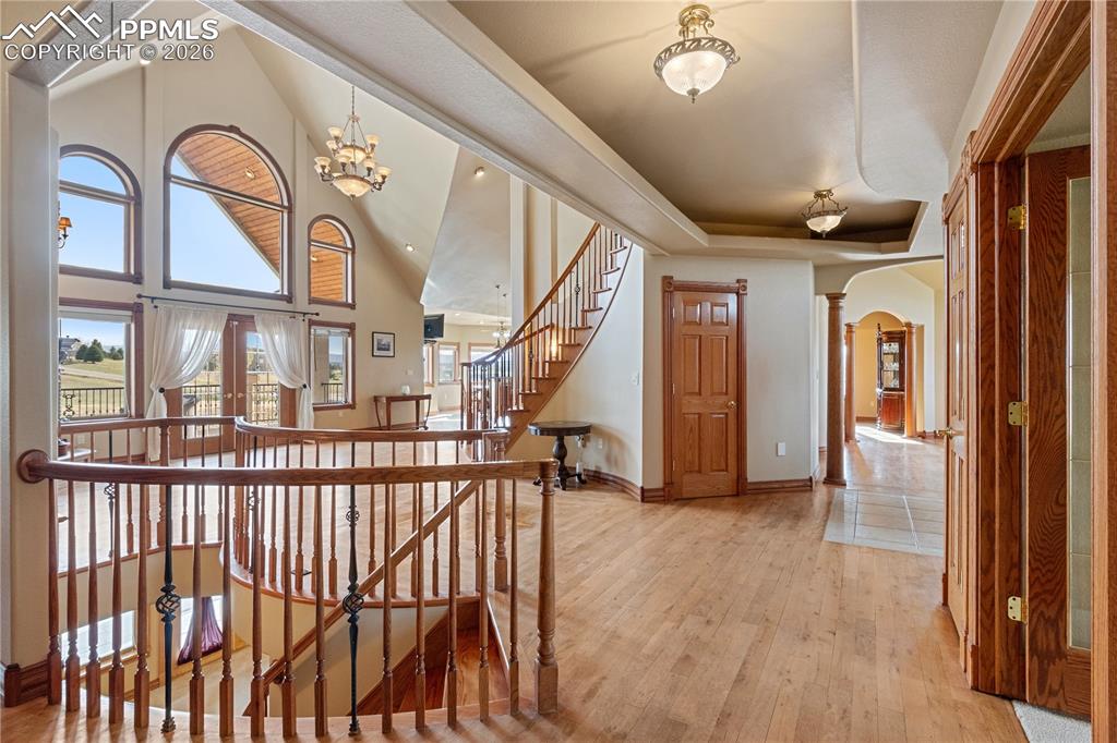 Image 19 of 50: Entryway and family room, door to 1/2 bathroom, stairs just in front down t