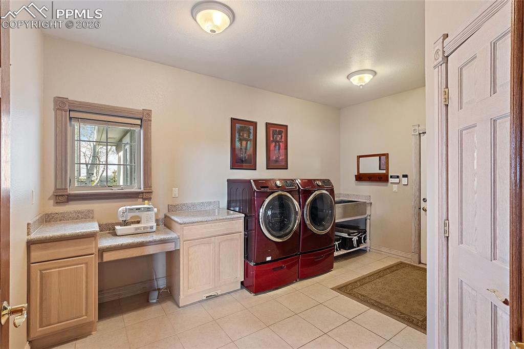 Image 22 of 50: Main floor laundry room with half bath and large storage closet to the righ