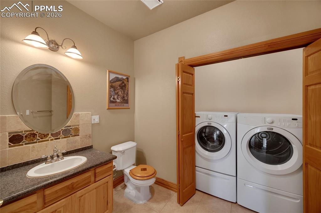 Image 39 of 50: Basement 1/2 bath with second laundry hookup  
