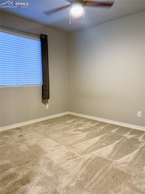 Image 10 of 14: Empty room with light colored carpet and a ceiling fan