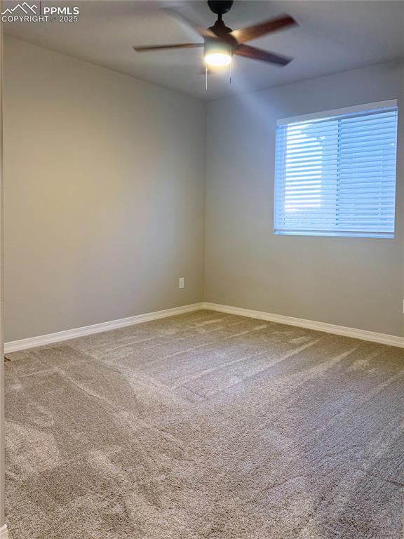 Image 11 of 14: Unfurnished room featuring light carpet and a ceiling fan