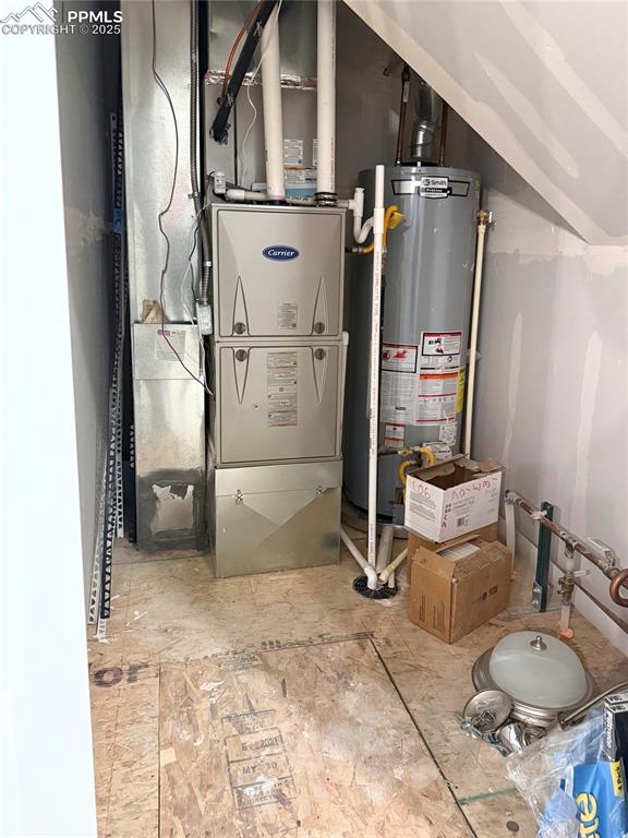 Image 14 of 14: Utilities featuring heating unit and gas water heater