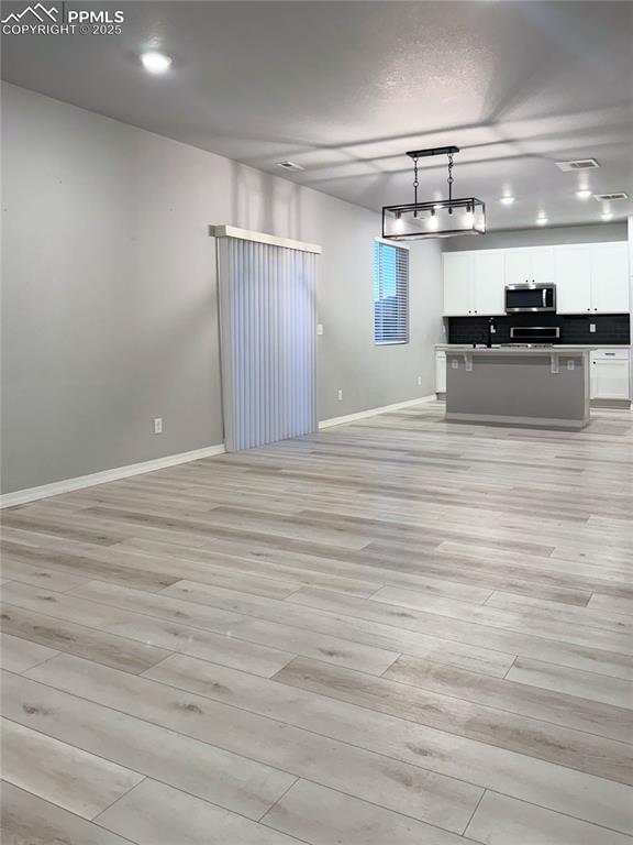 Image 3 of 14: Unfurnished living room featuring light wood-style floors, recessed lightin