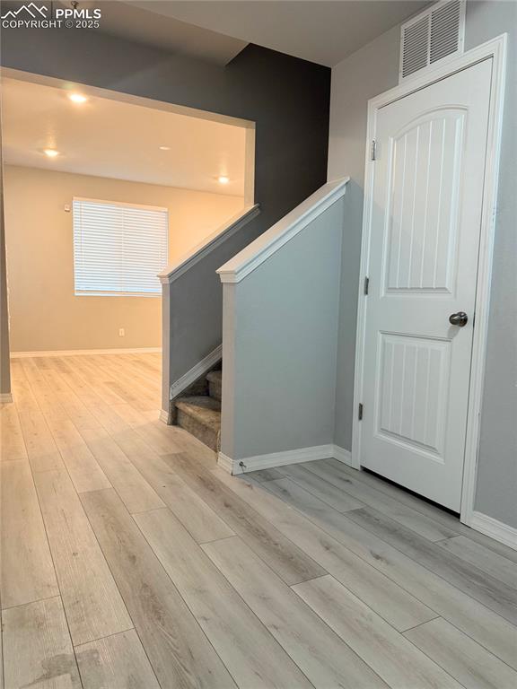 Image 5 of 14: Hall featuring light wood-style floors, stairway, and recessed lighting