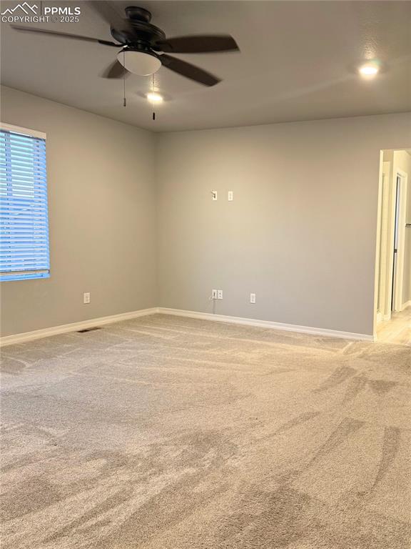 Image 6 of 14: Empty room with light carpet and a ceiling fan