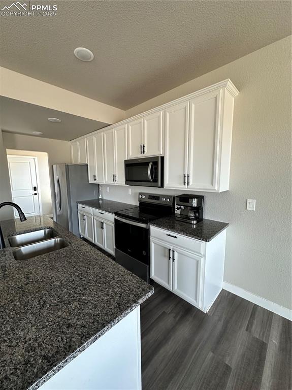 Image 6 of 19: Kitchen featuring stainless steel microwave, range with electric cooktop, w