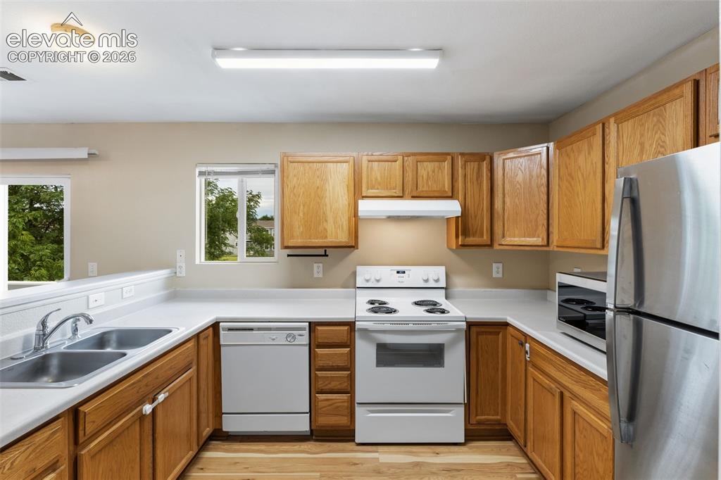 Image 12 of 27: The Kitchen has an abundance of cabinets and comes equipped with a Refriger