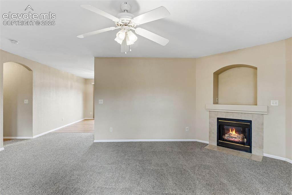 Image 3 of 27: The spacious Living Room features natural lighting from the home