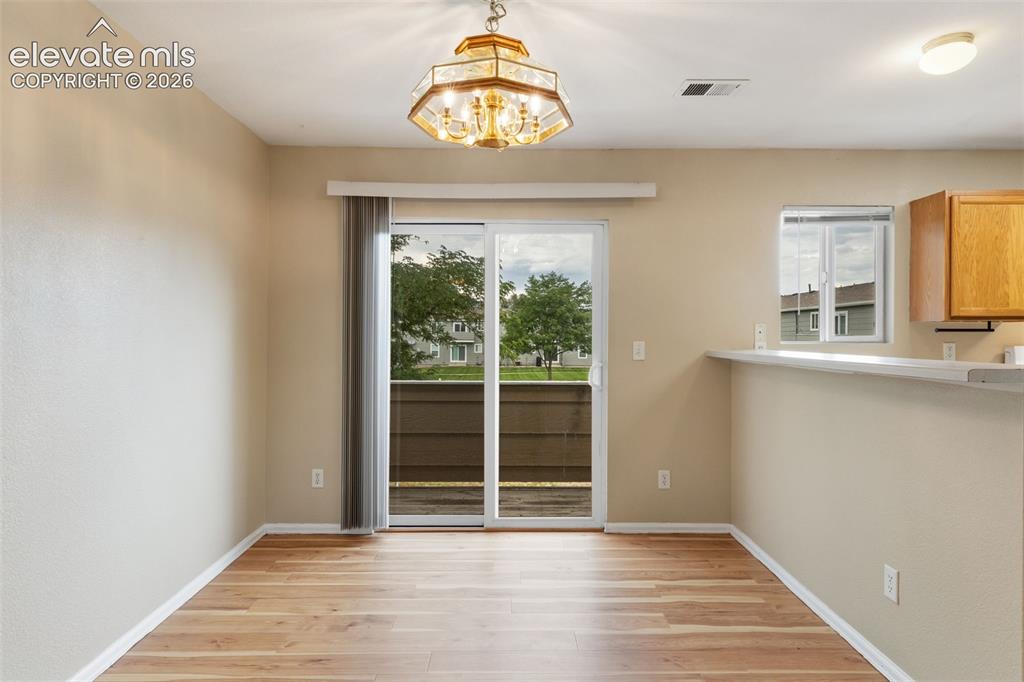 Image 8 of 27: The Dining Area showcases a sliding glass door which provides access to the