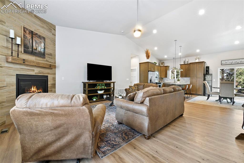 Image 16 of 40: Open Living Concept with Vaulted Ceiling, Can Lighting and Luxury Vinyl Pla