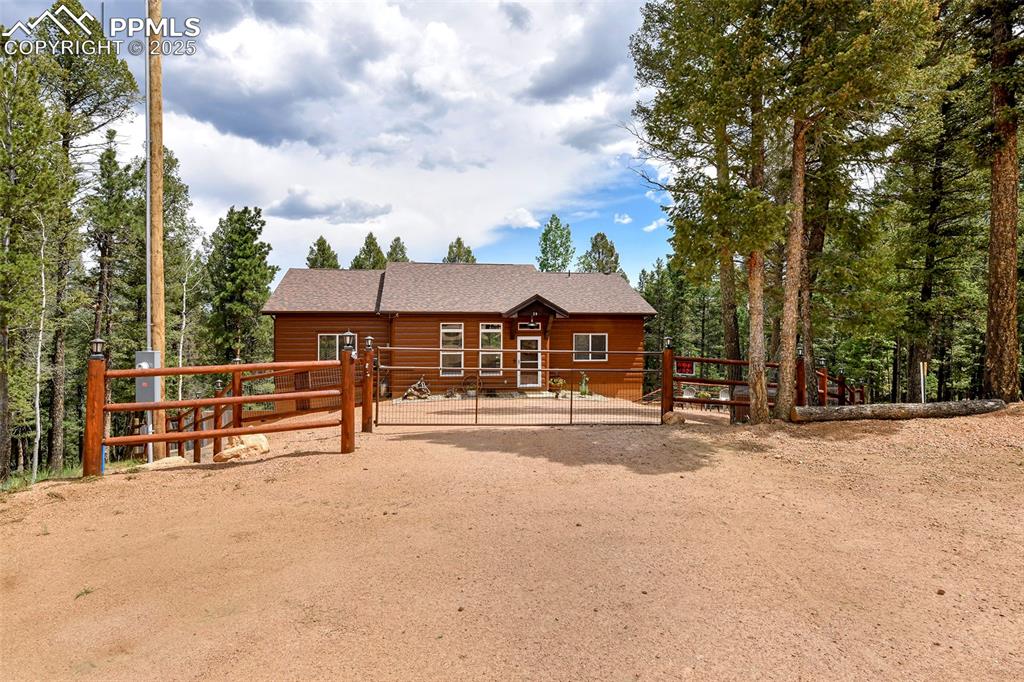 Image 2 of 40: Beautiful Setting of the Front of the Home with Dog Friendly Fencing and Ga
