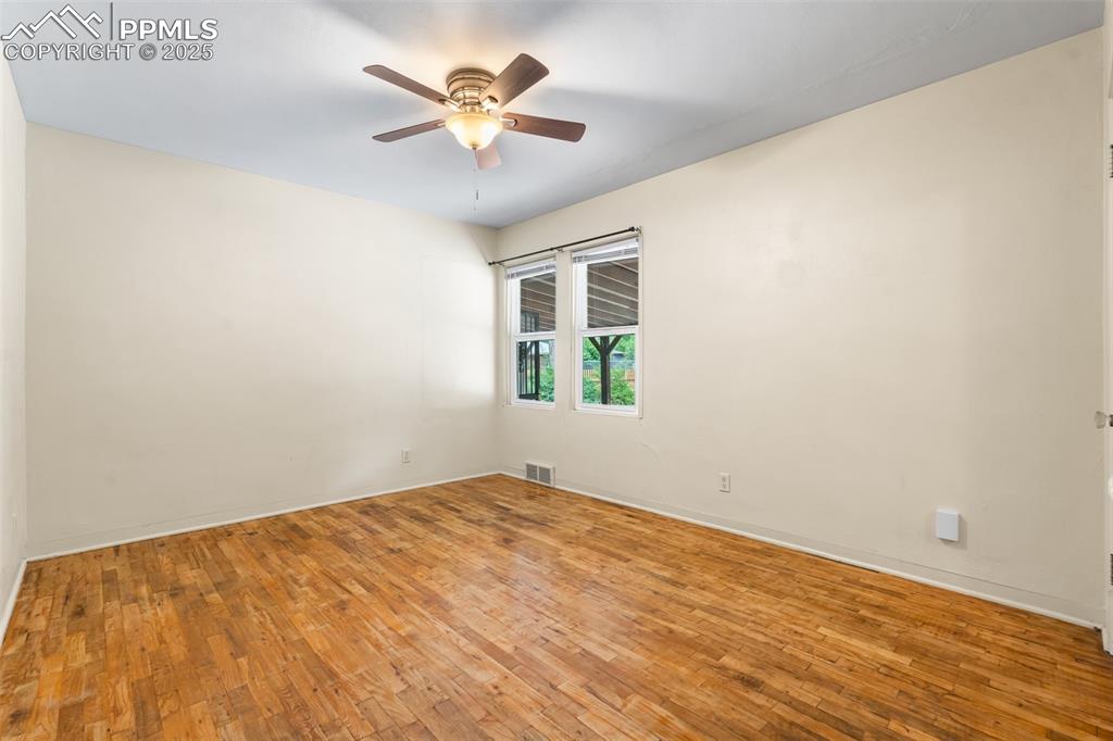 Image 16 of 41: Spare room with hardwood / wood-style flooring and a ceiling fan