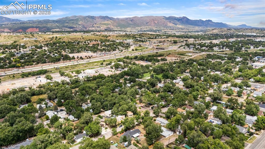 Image 35 of 41: Aerial perspective of suburban area with a mountain backdrop