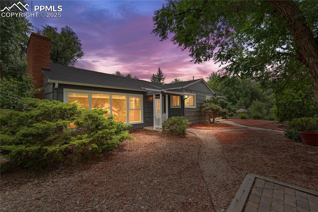 Image 39 of 41: View of front of home with a chimney