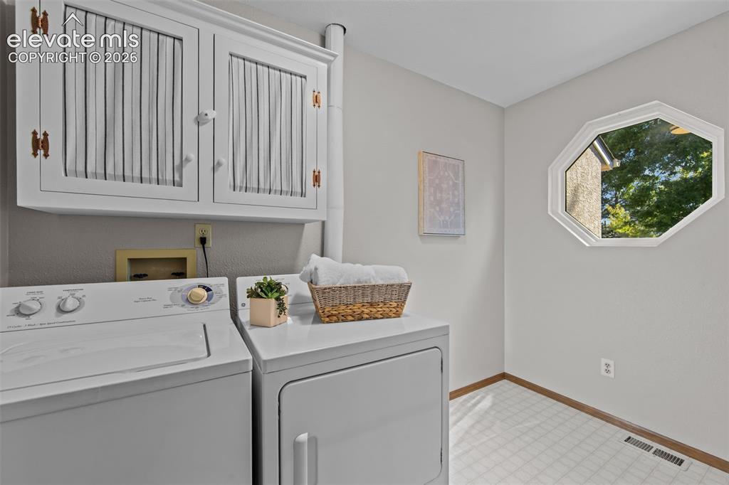 Image 23 of 35: Awesome laundry room with tons of light