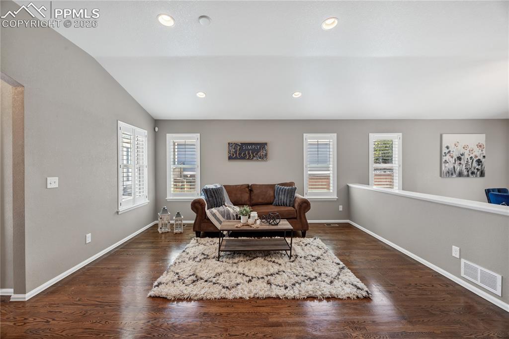 Image 13 of 40: Cool paint tones and recessed lighting along with the gas fireplace make th