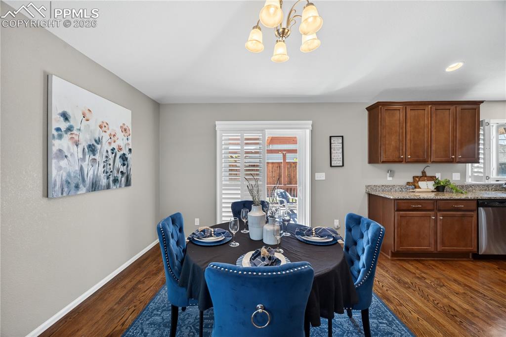 Image 15 of 40: The Living Room has a subtle pony wall separating the Dining Area 