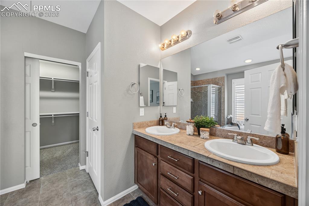 Image 23 of 40: Stainless steel appliances include a dishwasher, smooth top range oven, bui