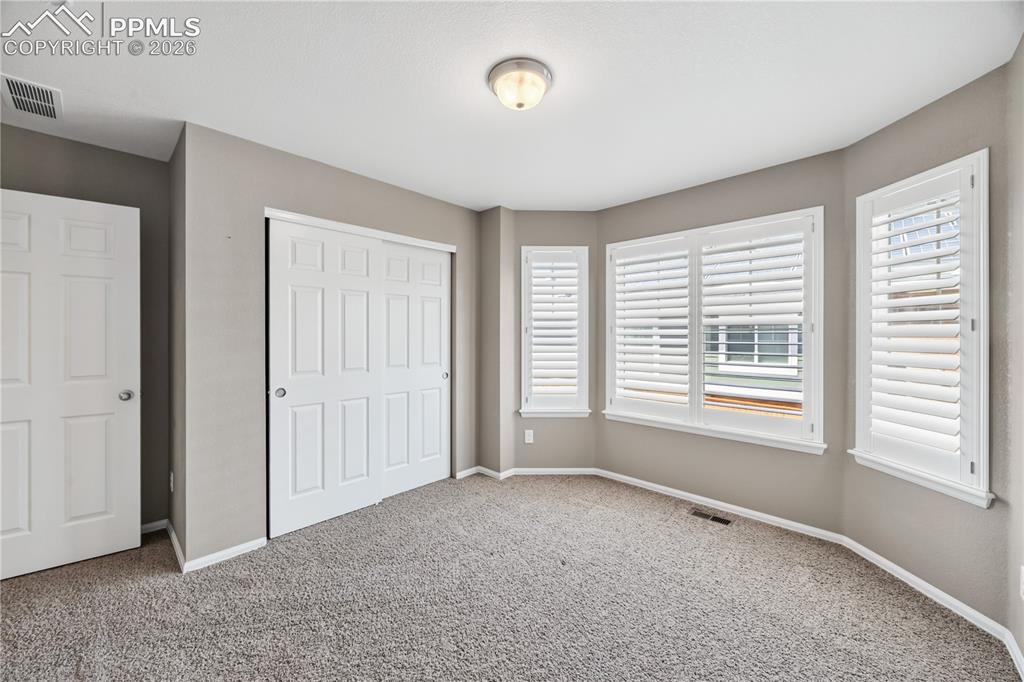Image 31 of 40: The Laundry Room offers a tile floor, storage and folding shelf, washer and