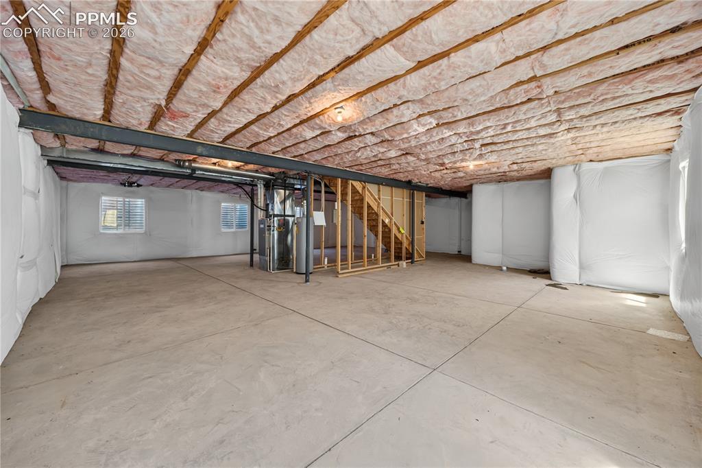 Image 37 of 40: Unfinished Basement ready for expansion with 5 windows and pre-plumbed for 