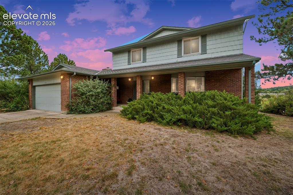 Image 3 of 40: Two-story residence featuring a brick and composite siding exterior, a cove