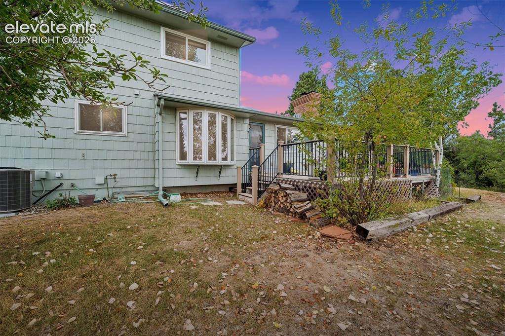 Image 4 of 40: Exterior featuring light-toned shingle siding, a multi-pane bay window, and